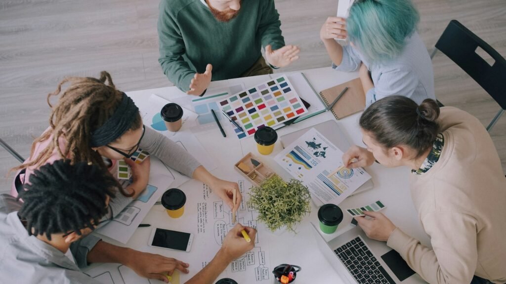 A group of people working together on design sketches at a table